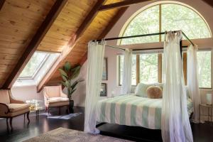 a bedroom with a canopy bed in a attic at Catskill Estate epic views hot tub in Kingston