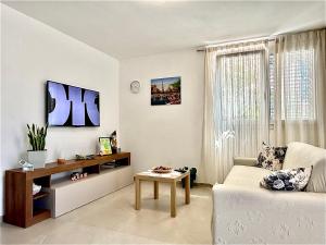 a living room with a couch and a table at Arsi House in Diano Castello
