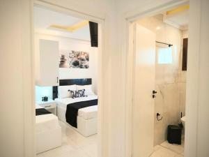 a white bedroom with a bed and a shower at Chrisella Crystal in Skala Rachoniou +29 photos
