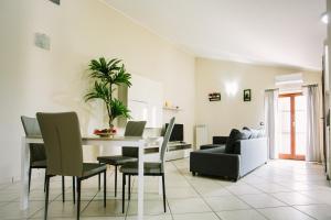 a dining room with a table and chairs and a couch at Your Penthouse in San Prisco