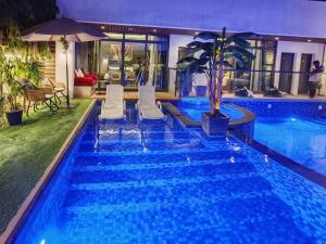 a swimming pool with blue water in a hotel at G R A N D C H A L E T in Salalah