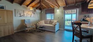 a living room with a couch and a table at Makri Heights in Makri