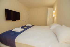 Ένα ή περισσότερα κρεβάτια σε δωμάτιο στο Orbi CIty Apartment