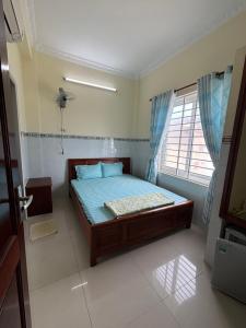 Ένα ή περισσότερα κρεβάτια σε δωμάτιο στο Motel Liên Anh