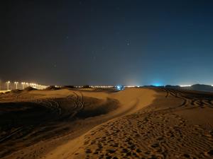 a dirt road in the desert at night at G R A N D C H A L E T in Salalah