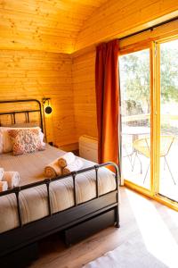 a bedroom with a bed and a balcony at Quinta do Prado Verde in Vilar Formoso +99 photos