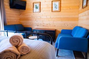 a room with a bed and chairs and a television at Quinta do Prado Verde in Vilar Formoso +89 photos