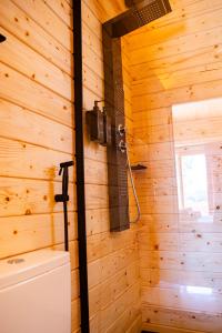 a bathroom with a shower in a wooden wall at Quinta do Prado Verde in Vilar Formoso