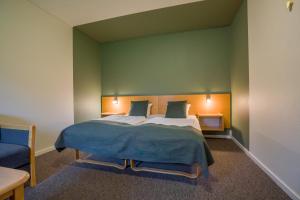 Rúm í herbergi á Hotel Hedemarken
