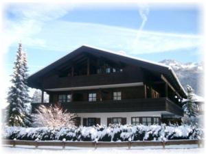 a large building with snow on the ground at FeWo-in-Unterwoessen-Chiemgau-Oberbayern in Unterwössen