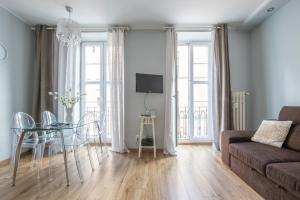 a living room with a couch and a glass table at Naptun Old Town by Alqueen Apartments in Gdańsk