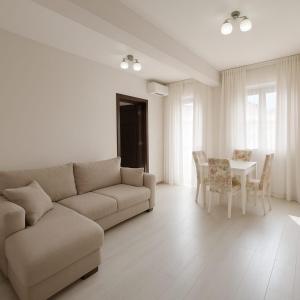 a living room with a couch and a table at Apartment Adrialux in Budva