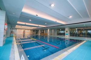 a large swimming pool in a large building at Pan Pacific Ningbo in Ningbo