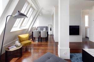 a living room with a yellow chair and a table at Playa de La Concha 7 by FeelFree Rentals in San Sebastián