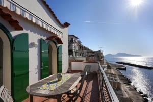 a balcony with a table and a view of the water at House Dream on the sea in Massa Lubrense