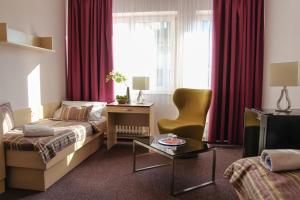 a hotel room with a bed and a table at Hotel Junior Poděbrady in Poděbrady +31 photos