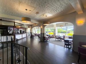 a dining room with tables and chairs in a restaurant at Rob Roy Hotel in Aberfoyle