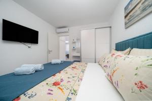 Postel nebo postele na pokoji v ubytování Apartmani Marivo