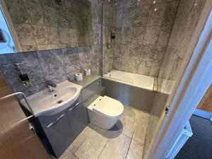 a bathroom with a toilet and a sink at Somerset Hotel Baker Street London in London
