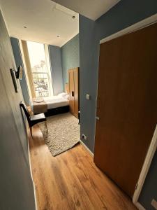 a room with a bedroom with a bed and a window at Somerset Hotel Baker Street London in London