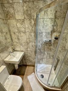 a bathroom with a shower and a sink at Somerset Hotel Baker Street London in London