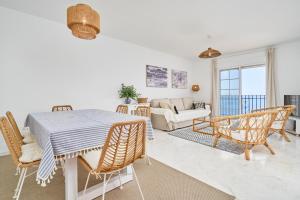 a living room with a table and chairs and a couch at Balcón del Mar in La Herradura