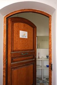 a wooden door with a sign on it at House Dream on the sea in Massa Lubrense +26 photos