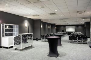 a conference room with tables and chairs and a screen at The Wade in Chicago