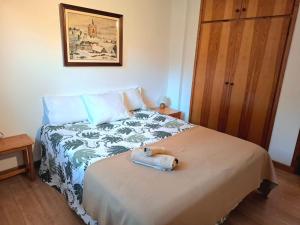 a bedroom with a bed with a towel on it at Isard Apartment in Pla de l'Ermita