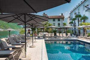 a pool with chairs and umbrellas next to a building at Hotel Rivalago in Sulzano +269 photos