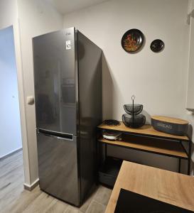a stainless steel refrigerator in a kitchen with a table at Vacation home Bujas in Pag