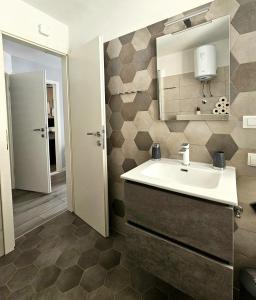 a bathroom with a sink and a mirror at Vacation home Bujas in Pag +30 photos