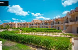 a view of an apartment complex with a green hedge at Coral Hills 2nd Row Chalet with Panoramic Sea View in Alexandria