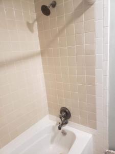 a bathroom with a shower with a white tub at Red River Gorge Farmhouse 50 Acres in Stanton +42 photos
