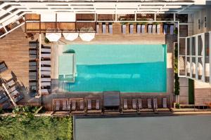an overhead view of a swimming pool with chairs at Athineon Hotel in Rhodes Town