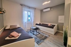 a bedroom with two beds and a window at Vacation home Bujas in Pag