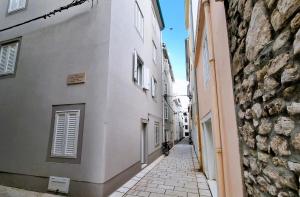 an alley between two buildings in a city at Vacation home Bujas in Pag
