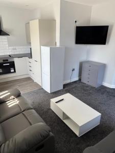 a living room with a couch and a white table at Royal Apartments SouthBank 1 in South Bank