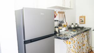 a kitchen with a stainless steel refrigerator at Estrella de Mar in Pedernales