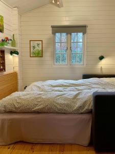 a bedroom with a bed and a window at Holiday Home With Views Of Nature In Ertebølle in Farsø +13 photos