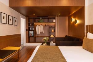 a living room with a bed and a couch at Hotel Le Colombier in Obernai