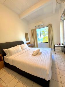 a bedroom with a bed with a towel on it at Corus Seaview Family Suite at Port Dickson 6-8 pax in Port Dickson