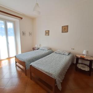 a bedroom with two beds and a window at Appartamento Angelina in Stresa