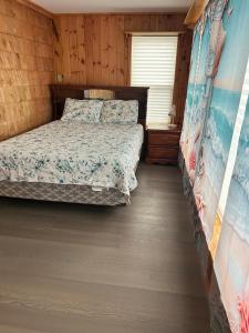 a bedroom with a bed in a wooden cabin at Whale Cove Suites in Digby