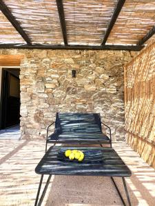 a bench with fruit on it on a patio at Farm House Near Of Merhia Beach In Mykonos in Merchia Beach