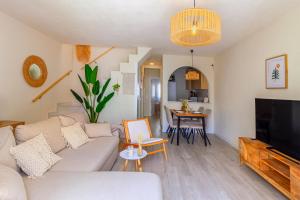 a living room with a couch and a tv at Espanatour SANTA ROSARIA in La Mata
