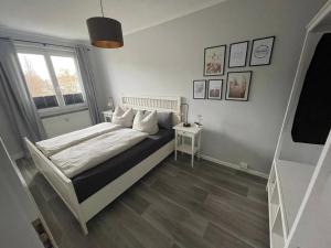 a bedroom with a bed and a window at Charming 4-Person Apartment in Hoyerswerda City Center in Hoyerswerda