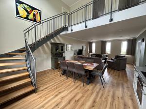a dining room and living room with a staircase at Feriendomizil im Saarschleifenland in Mettlach