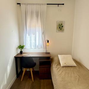 a bedroom with a desk and a bed and a window at Lo de Nieves - Casa con hermosa vista al pueblo y gran ubicación in Cachí +7 photos