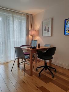 a desk with a laptop and chairs in a room at LGBTQ-Double room in London